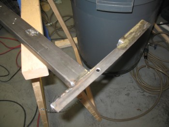 Cross bar tack welded to left side rail