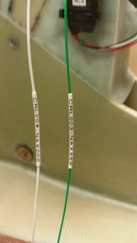 Wire labels shrunk in place