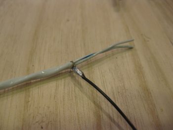 Ground wire soldered to shielding on landing light cable